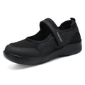 Women's grey casual slip-on shoe with mesh upper and Velcro strap on a flat sole.