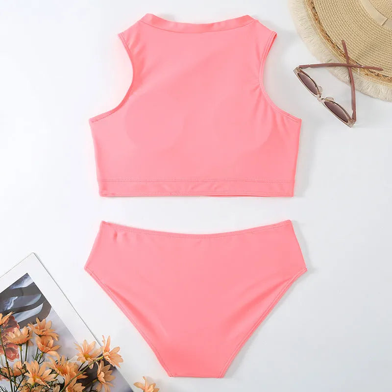 Pink high-waist bikini swimsuit with split-leg briefs and matching bra on a mannequin.