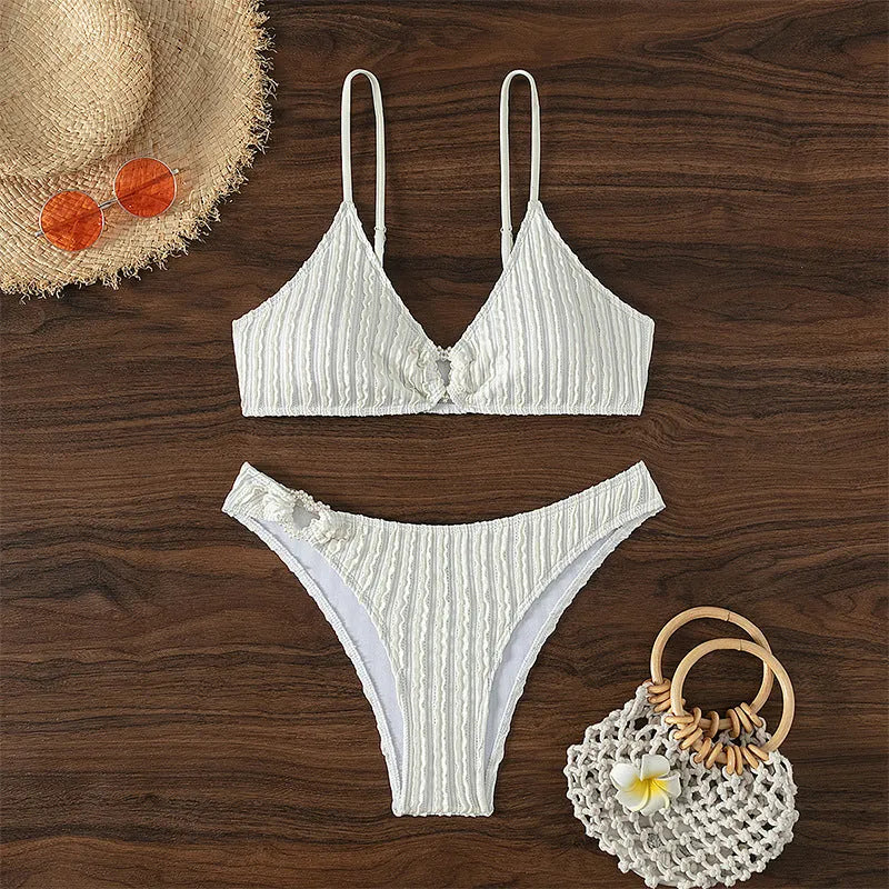 White women's V-neck swimsuit set with matching shorts for beach swimming