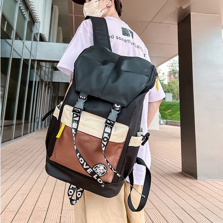Oxford cloth backpack in black, green, or red with handheld grip and shoulder straps.