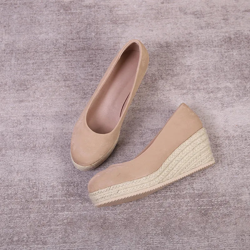 Women's apricot wedge heel pumps with rope-textured sole and shallow V-cut opening on a white background.