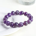 Natural Snow Mountain Purple Feather Amethyst crystal bracelet with scattered geometric beads featuring a Ruyi pattern.
