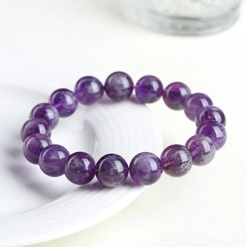 Natural Snow Mountain Purple Feather Amethyst crystal bracelet with scattered geometric beads featuring a Ruyi pattern.