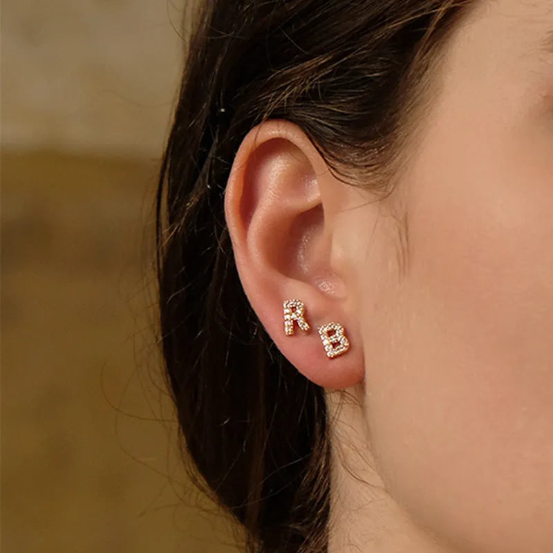 Gold plated alphabet letter earrings with zircon details showing English character design