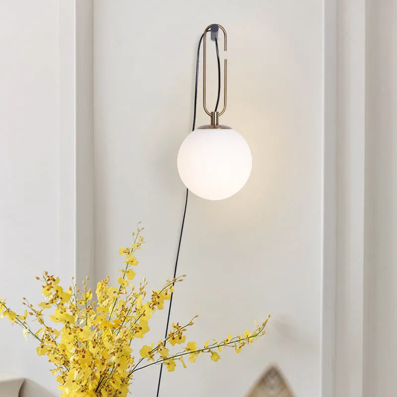 Nordic modern glass wall lamp mounted on a wall, showcasing its translucent design.