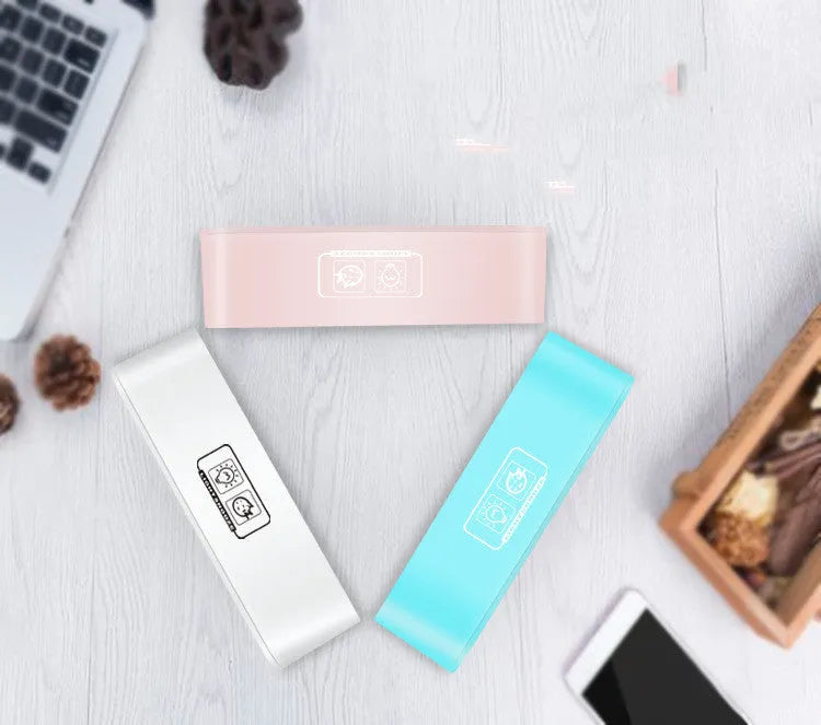 Blue rectangular LED alarm clock with atmosphere lighting on a wooden desk.