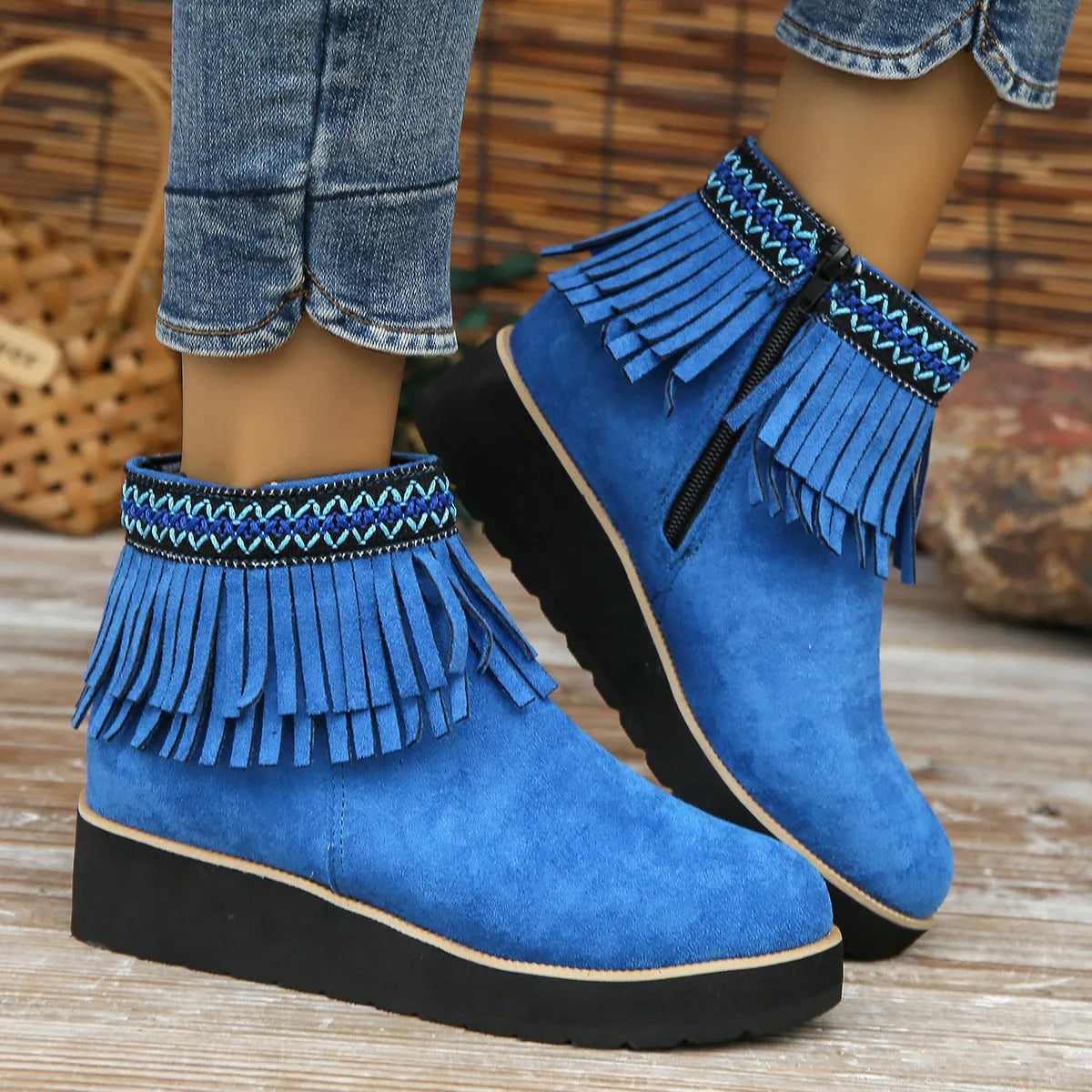 Women's dark brown suede wedge ankle boots with a side zipper and decorative tassel.