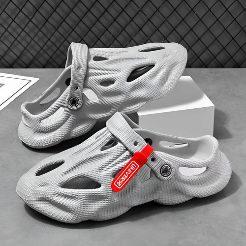 Pair of gray closed-toe EVA coconut slippers with a textured frosted finish and perforated upper.