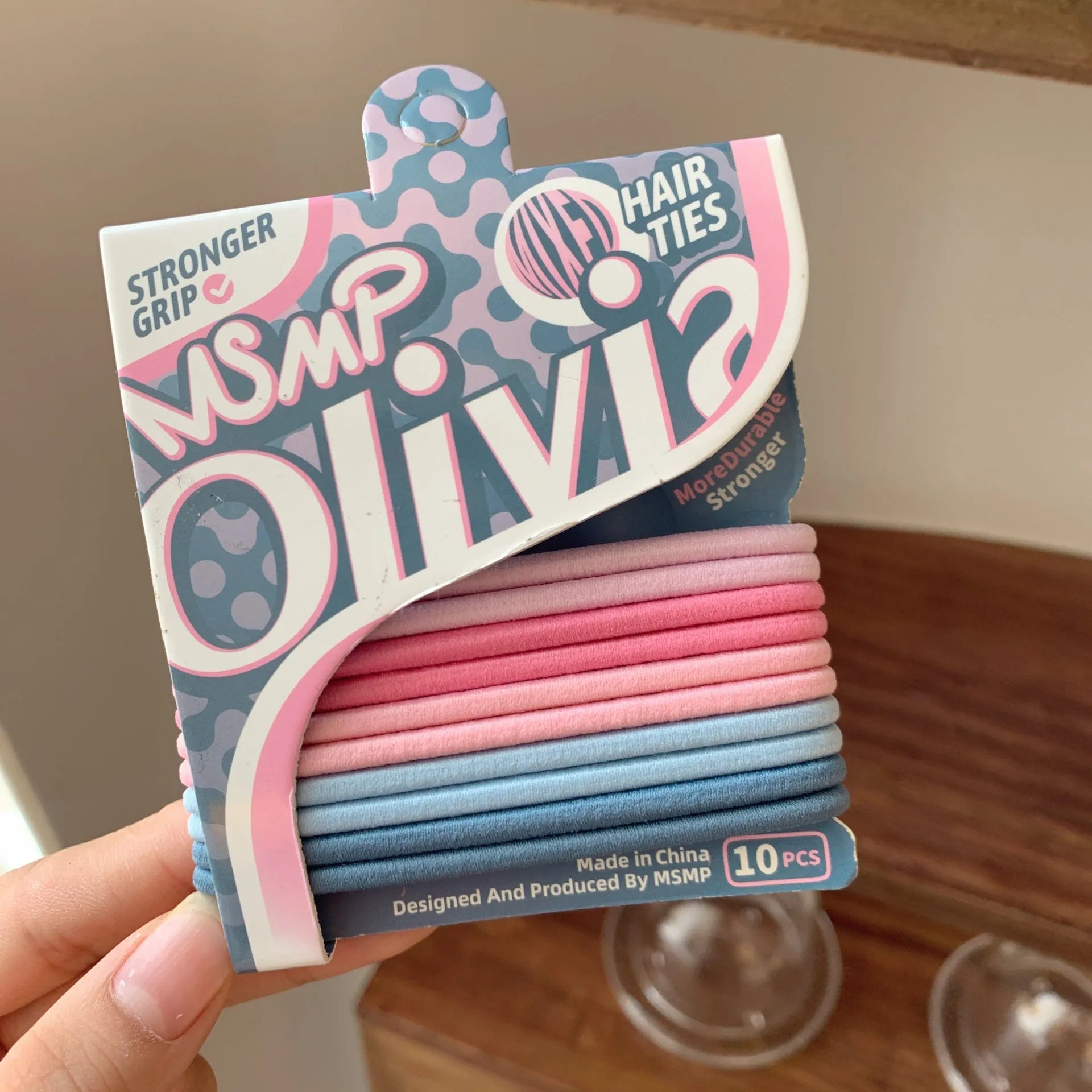 Assortment of candy-coloured braided elastic hair ties on a white background.