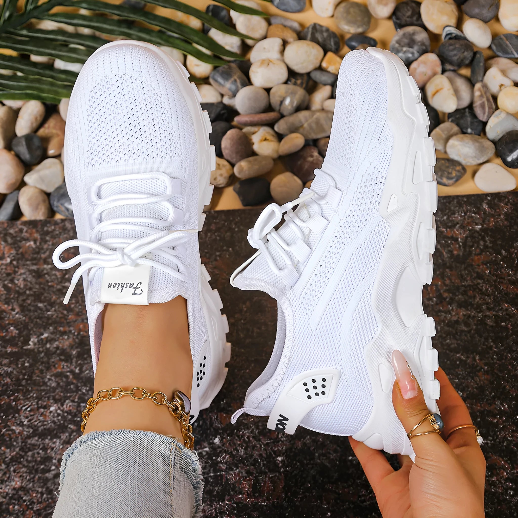 Women's low-top white mesh sports shoes with platform sole and front laces on a grey background.