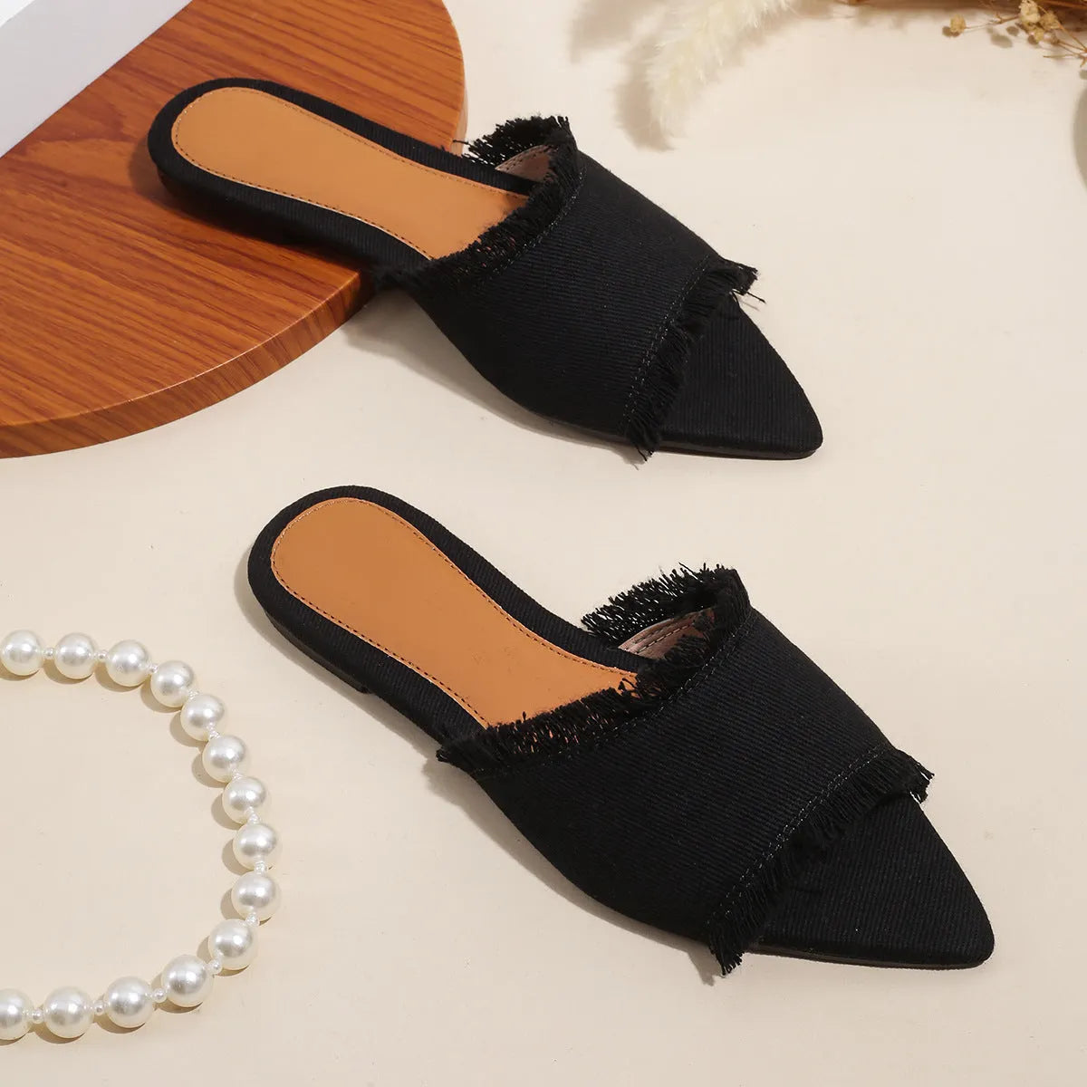 Women's casual denim flat slippers with leather lining and tassel detail.