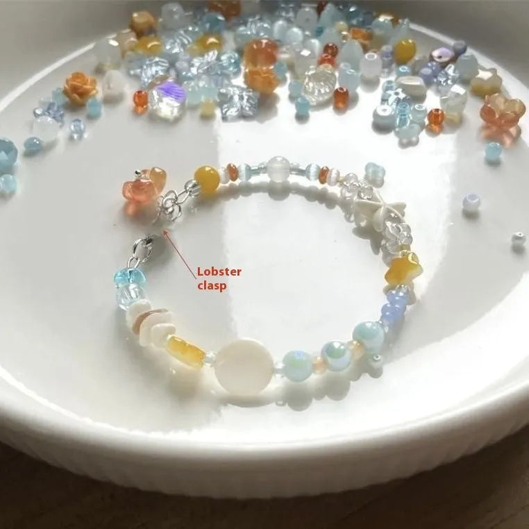 Orange mixed material alloy bracelet for women with diamond shapes and round elements.