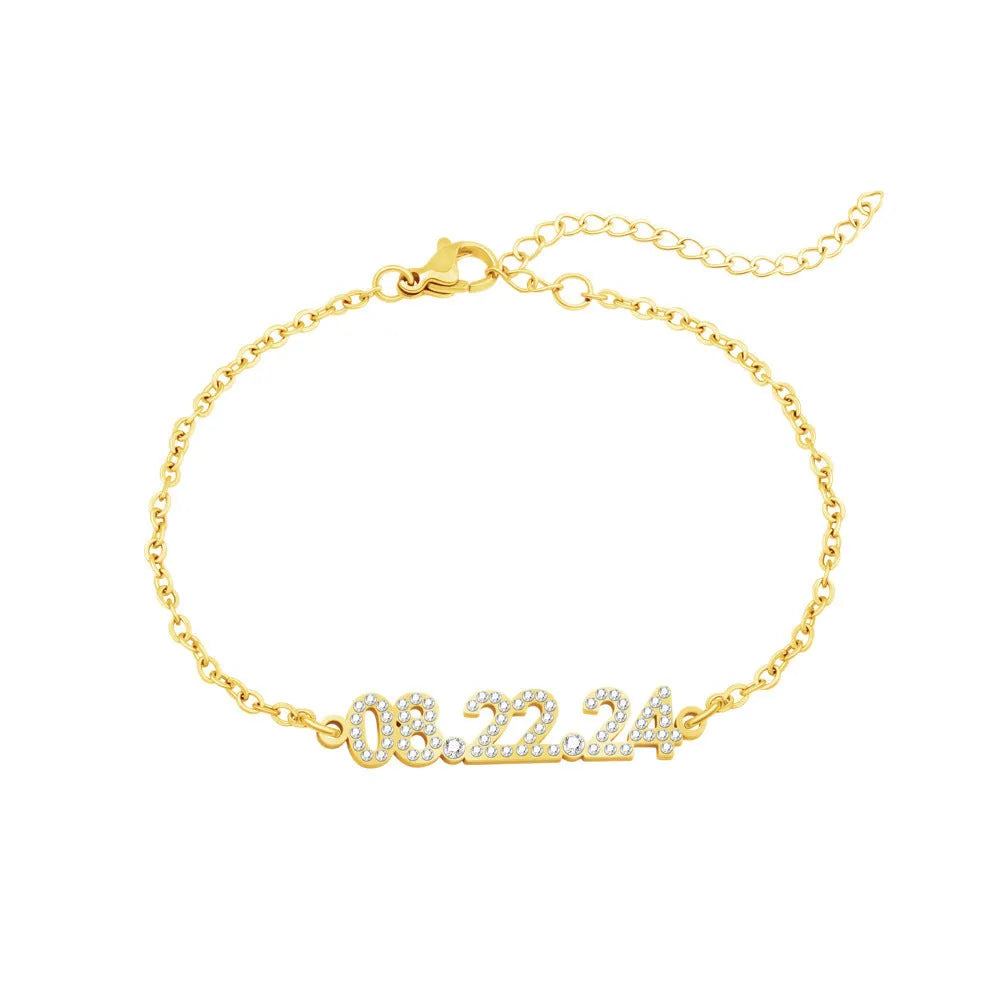 Stainless steel digital bracelet or necklace with diamond-set numbers on display, shown in gold colour.
