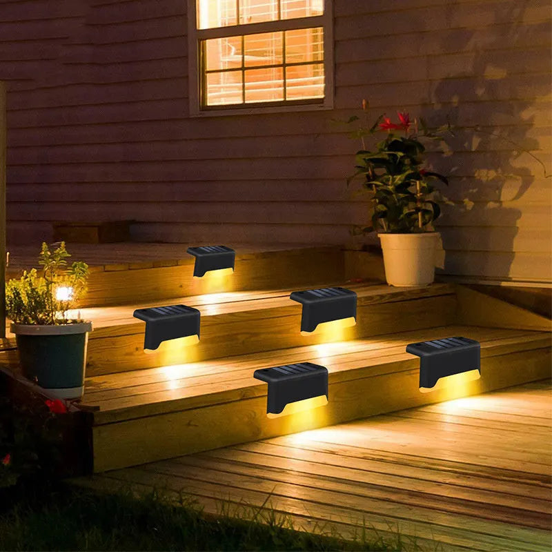 black solar courtyard stair light with ABS body on a garden step