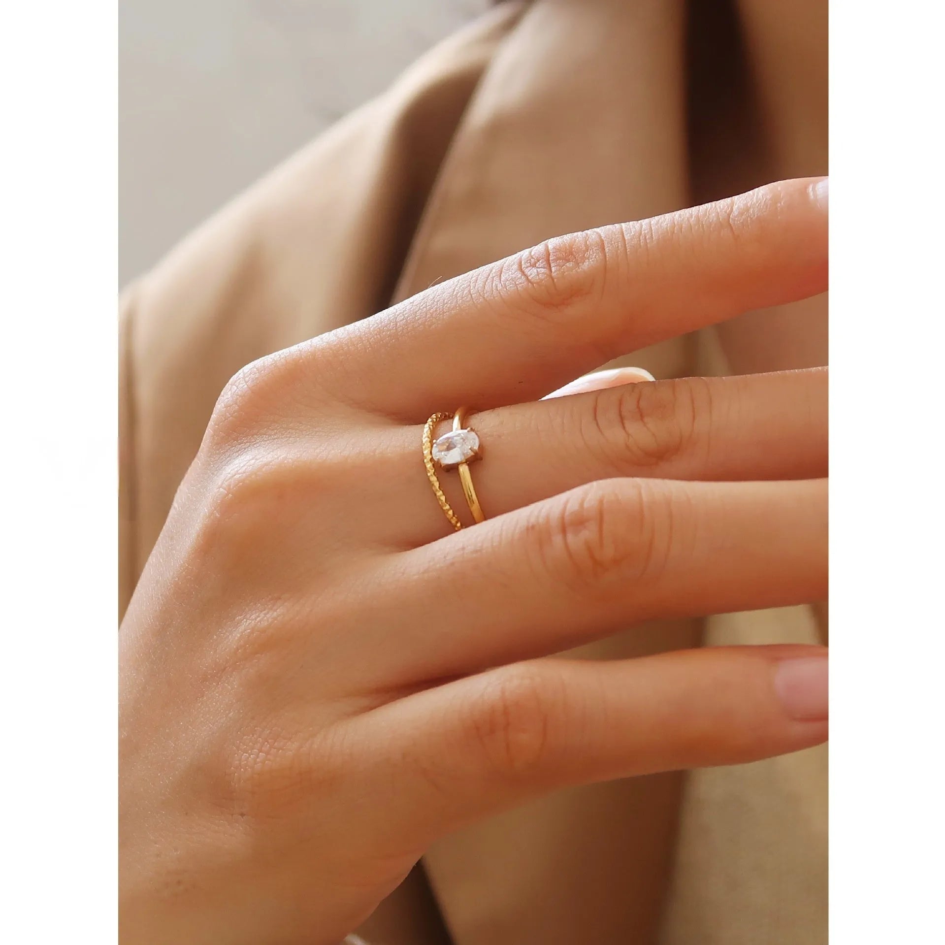 Golden heart-shaped stainless steel ring with love oval design on female hand