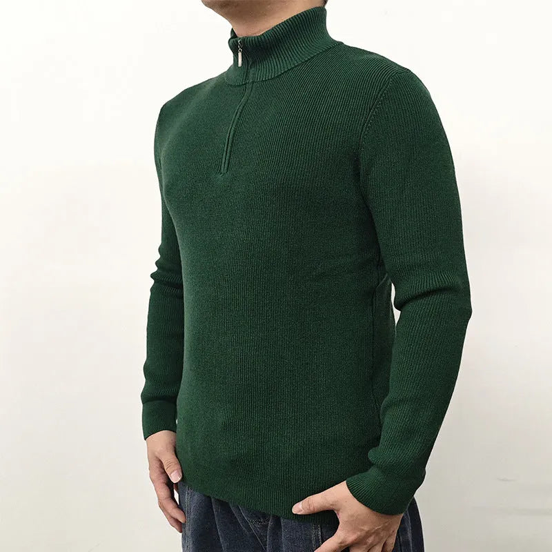 Man wearing a gray zip-front half-turtleneck long sleeve cotton blend sweater.