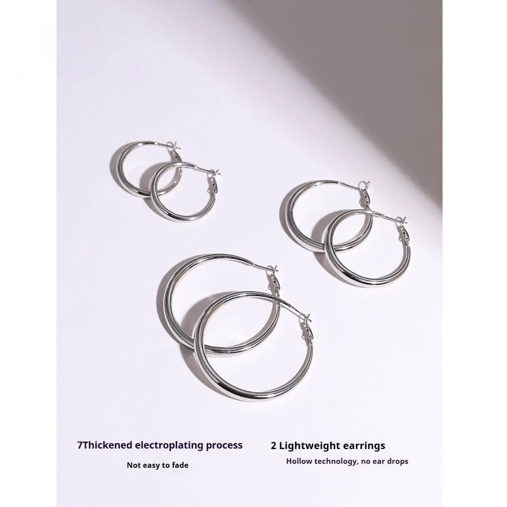 Silver needle big circle bracelet and earrings set with electroplated platinum finish on light background, three size options
