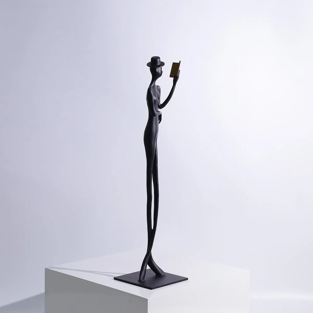 Tall black cast aluminium minimalist character sculpture on a desk, measuring 51cm in height.