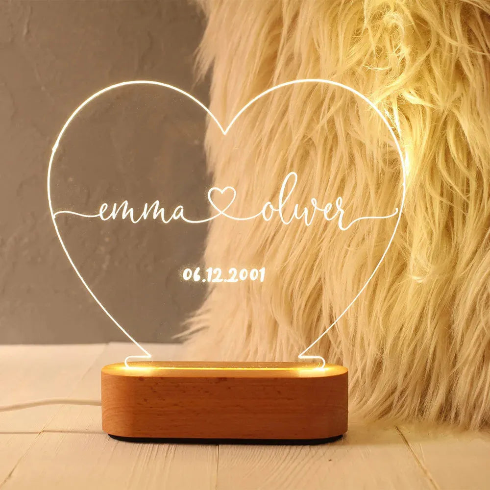 Custom engraved acrylic night light with LED base, showing personalised names and date.