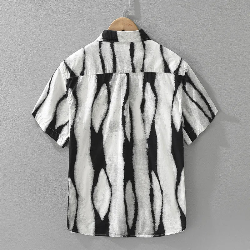 Man wearing a black and white striped pure cotton short sleeve shirt with a loose cardigan fit.