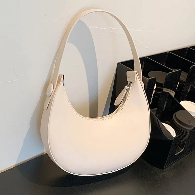 Women's cream yellow retro dumpling-shaped PU leather shoulder bag showing front and internal zippered pocket.