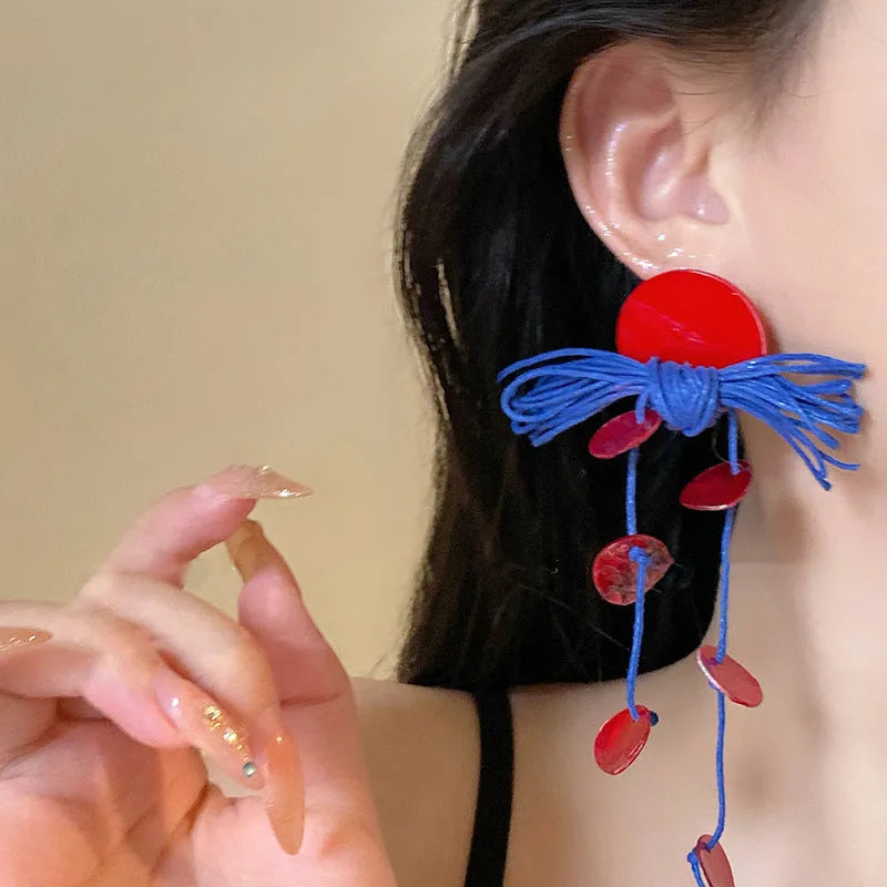 Blue geometric earrings with resin flower detailing and cloth material construction