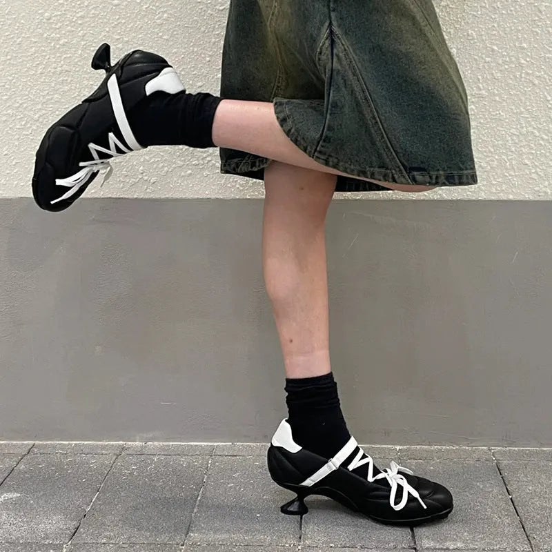 Women's silver low-top sports shoes with front lace-up and bow detail on a round toe.