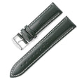 Quick-release cowhide leather watch strap in black with white accent line, showing the spring bar mechanism.