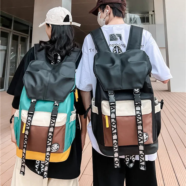Oxford cloth backpack in black, green, or red with handheld grip and shoulder straps.