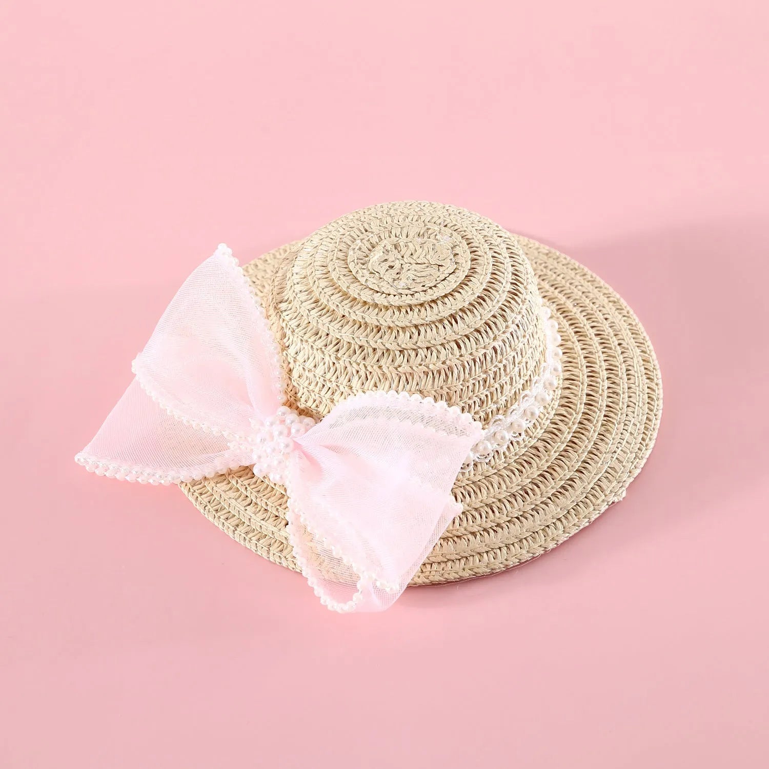 Woven straw hat for a cat with a pearl butterfly bow, shown in pink, purple, blue, or white colour options.