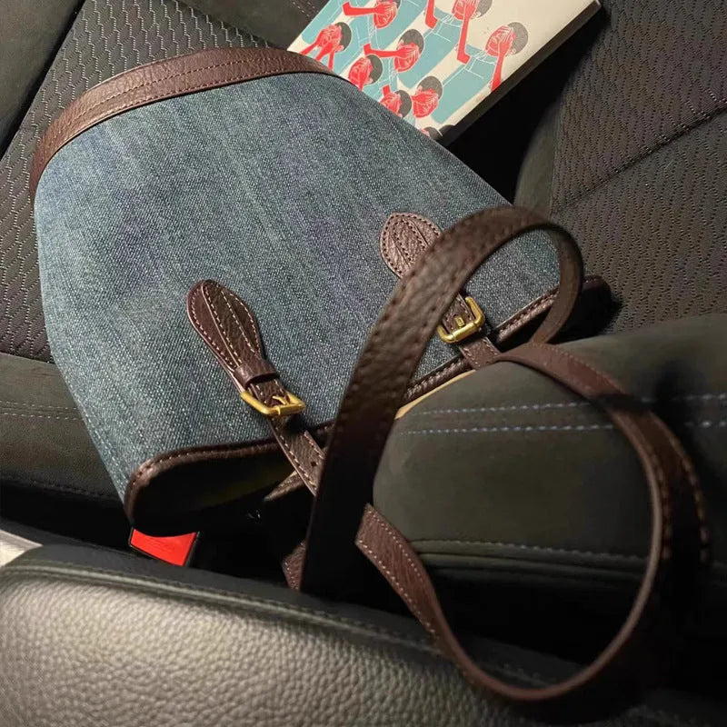 Blue denim patchwork one-shoulder bucket handbag with a large opening.