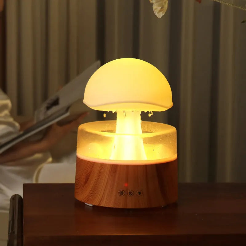 White rain cloud shaped ultrasonic humidifier and aroma diffuser with LED lighting showing rainfall simulation effect