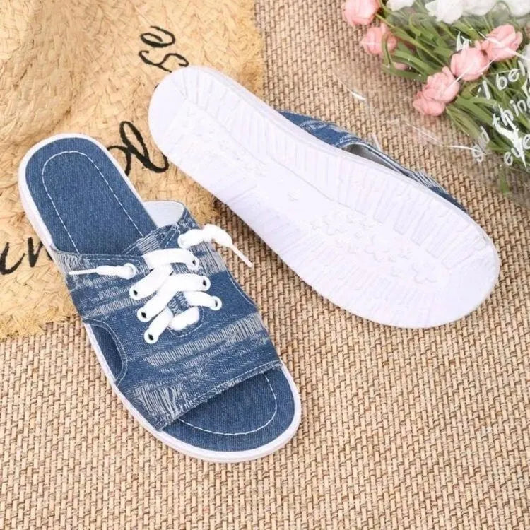 Blue Roman-style women's canvas slippers with rubber soles showing flat design and cloth upper material