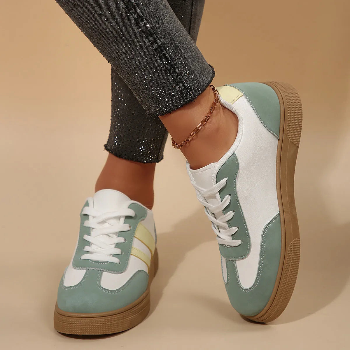 Women's retro sports shoes in white with green candy colour accents and cross-strap details on PU leather upper.