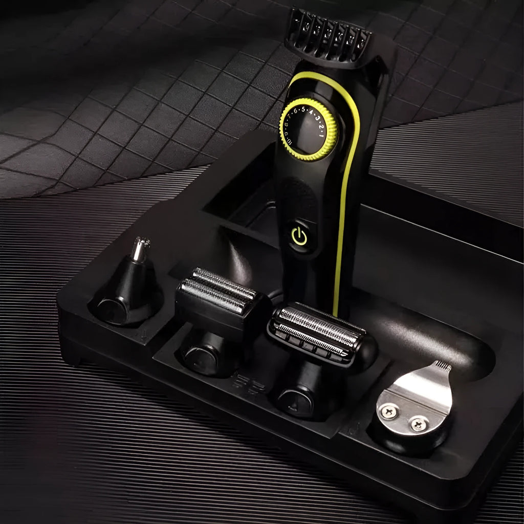 Black KM-696 USB rechargeable electric hair clipper set with stainless steel blades and accessories on a cloth