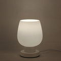 Nordic touch glass desk lamp with three colour settings and USB port on bedside table