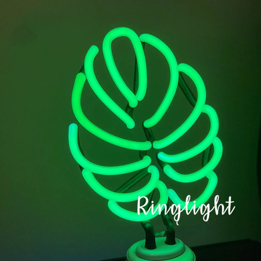 Minimalist bamboo-shaped white desk lamp with green illumination on wooden desktop