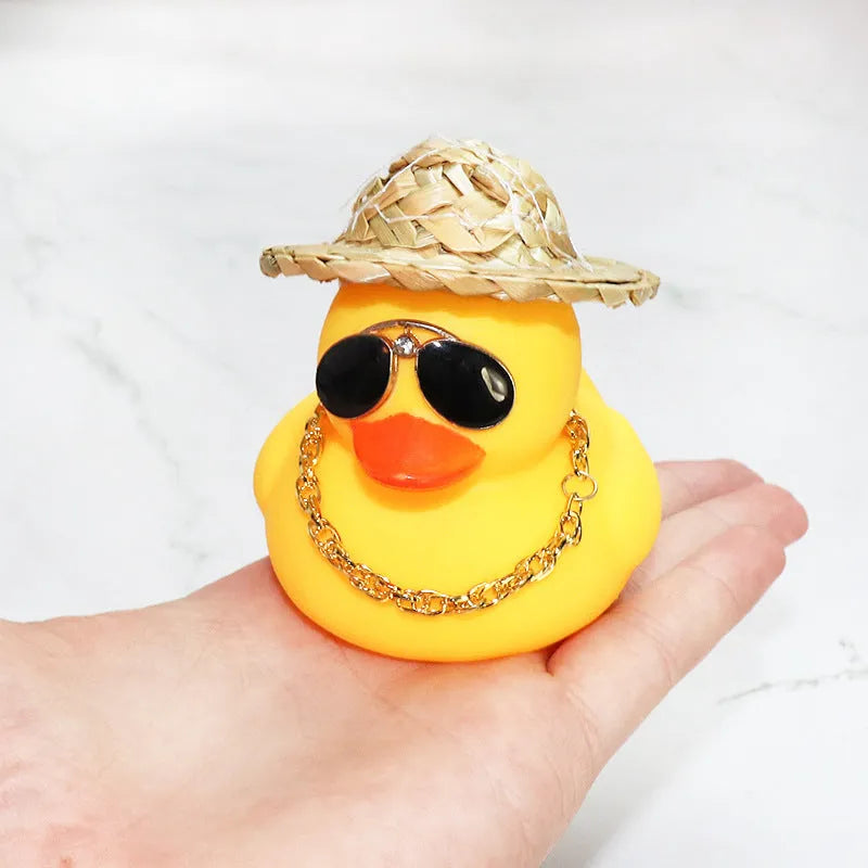 Yellow duck car dashboard ornament with straw hat, matte finish, and included adhesive base with sunglasses necklace