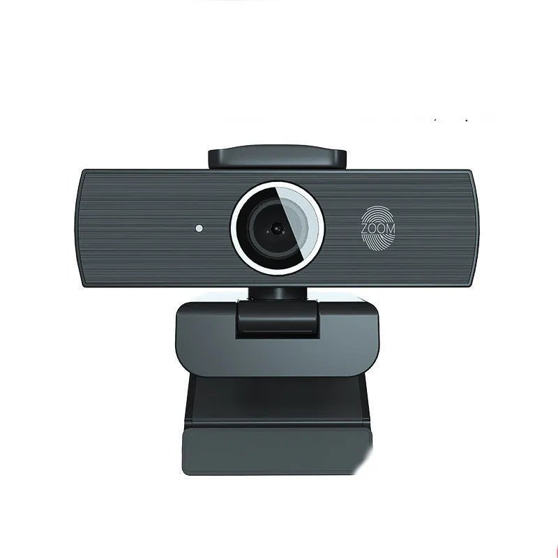 Black 8MP USB webcam with a magnetic privacy cover attached, shown next to its cable and manual.