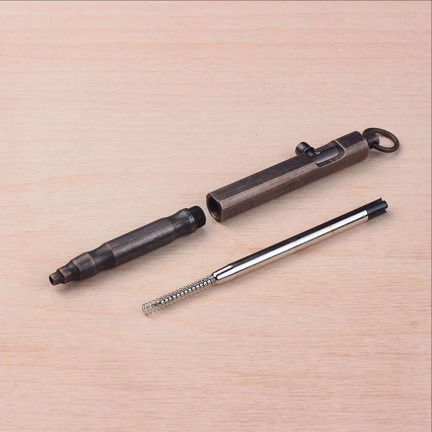 Brass tactical pen with machine gun inspired bolt-action design and hexagonal barrel