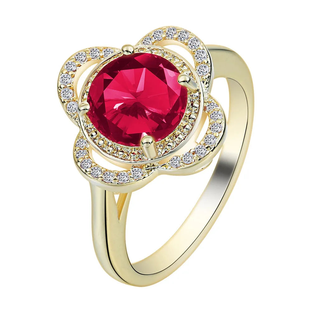 Copper ring with fruit shape and inlaid zircon details on a finger.