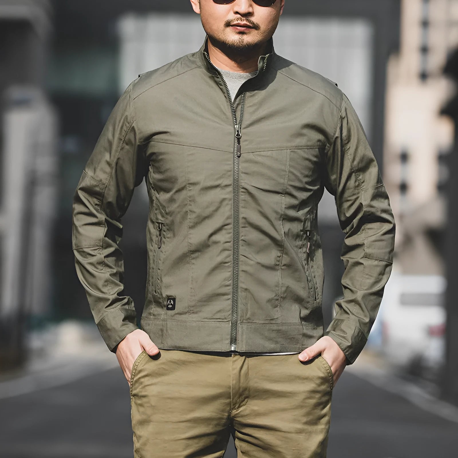 Men's brown polyester tactics assault jacket with camouflage pockets on a mannequin.