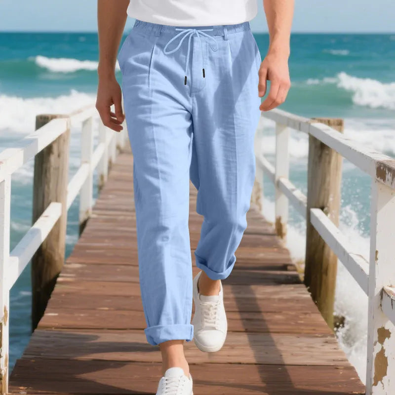 Men's light beige linen casual trousers with drawstring waist and straight-leg fit on a hanger.