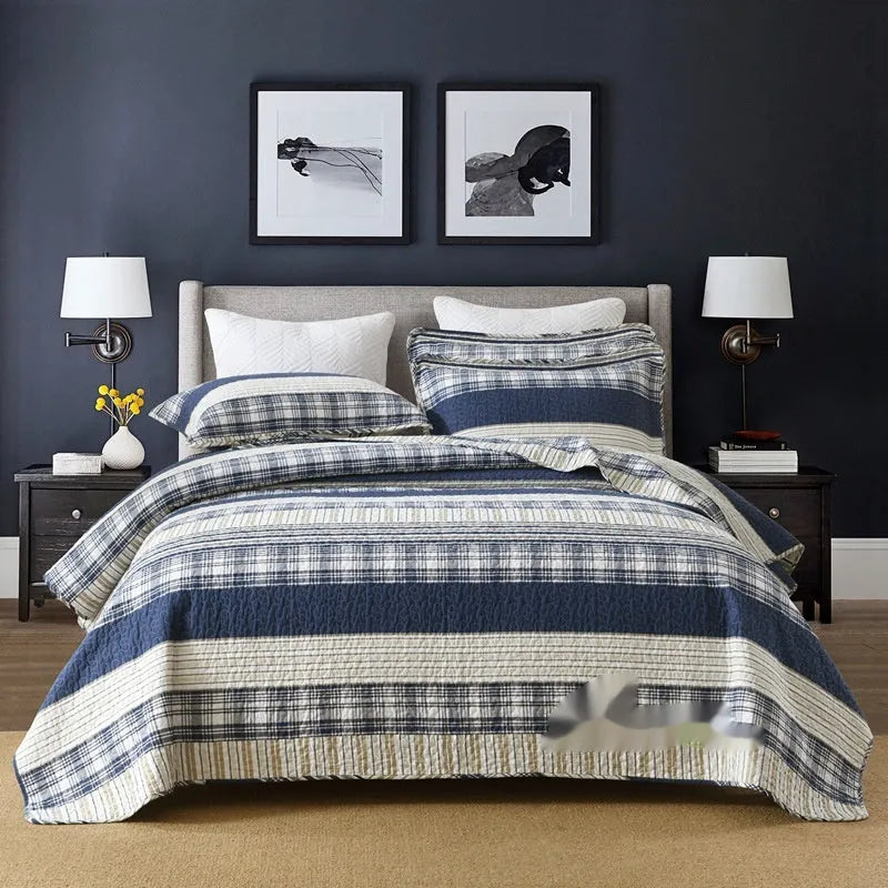 Quilted pure cotton bed cover set with printed pattern on a bed, includes two matching pillowcases.