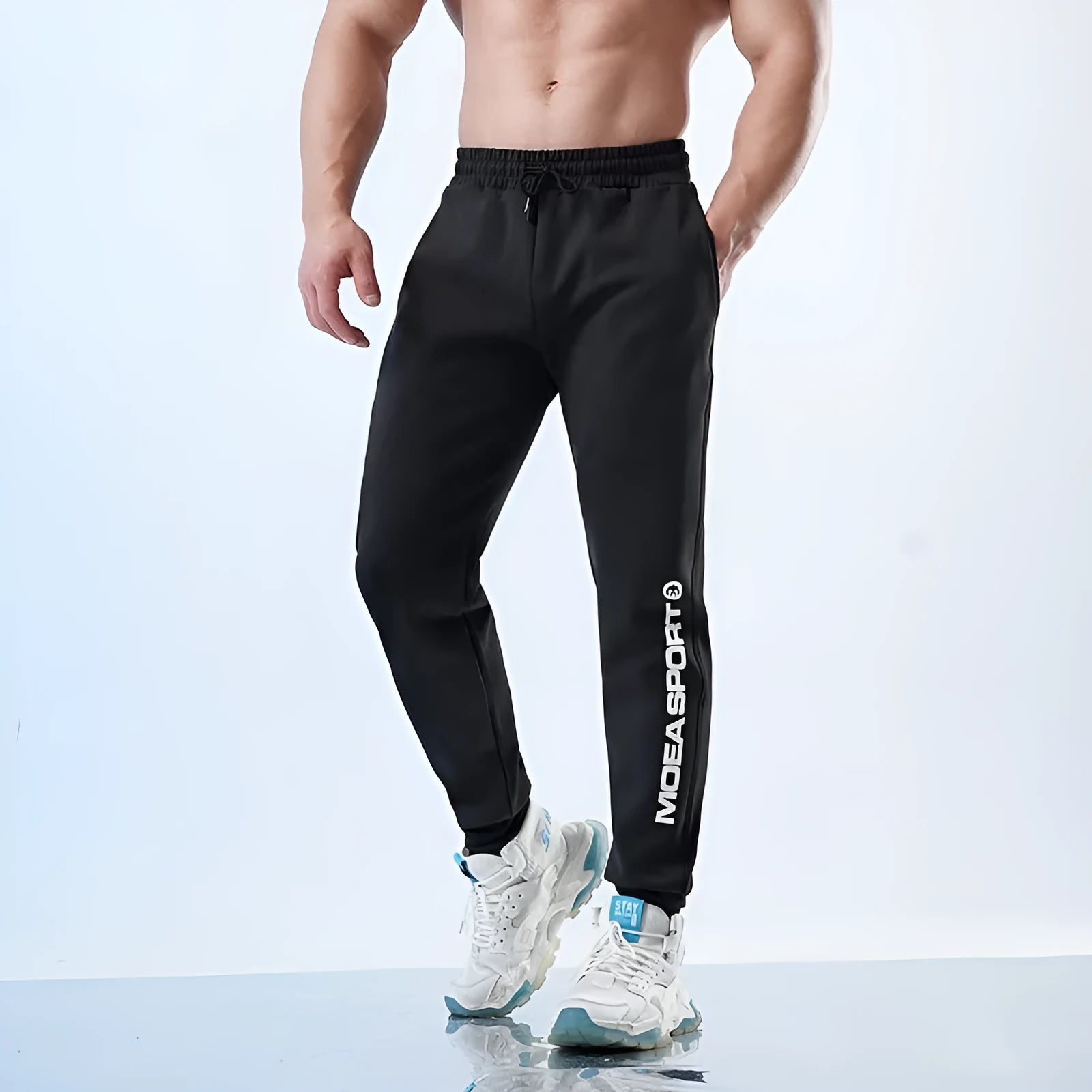 Men's black ankle-tied sweatpants with mid-waist design and polyester-spandex blend fabric