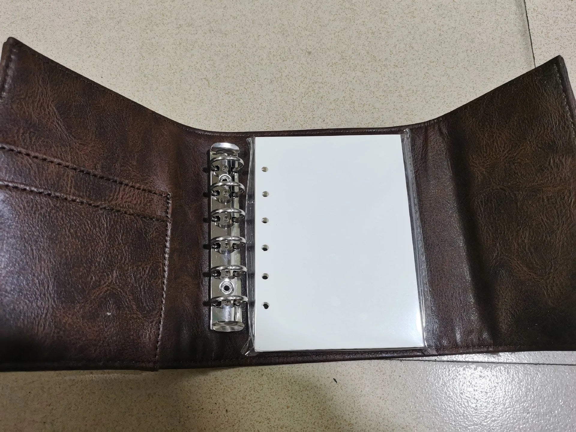 Brown retro leather buckle notebook with loose-leaf binder binding and A7 size format