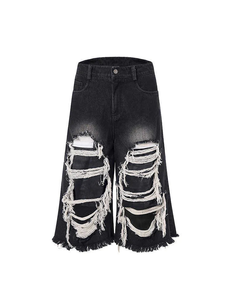 Black women's cropped wide leg jeans with mid-high waist and ripped patch detail