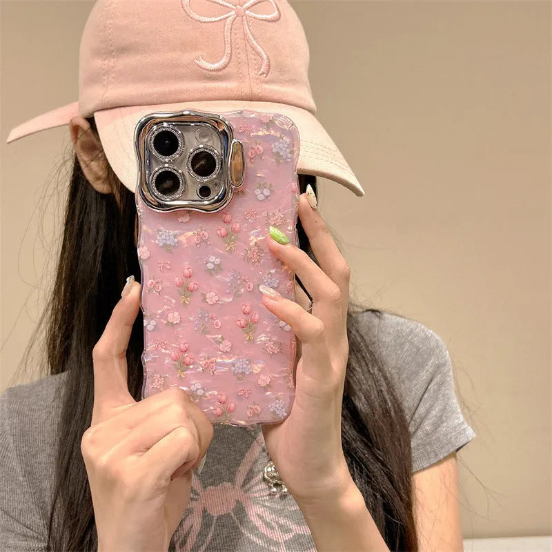 Wave white acrylic iPhone case with embossed floral shell pattern and invisible bracket on a plain background