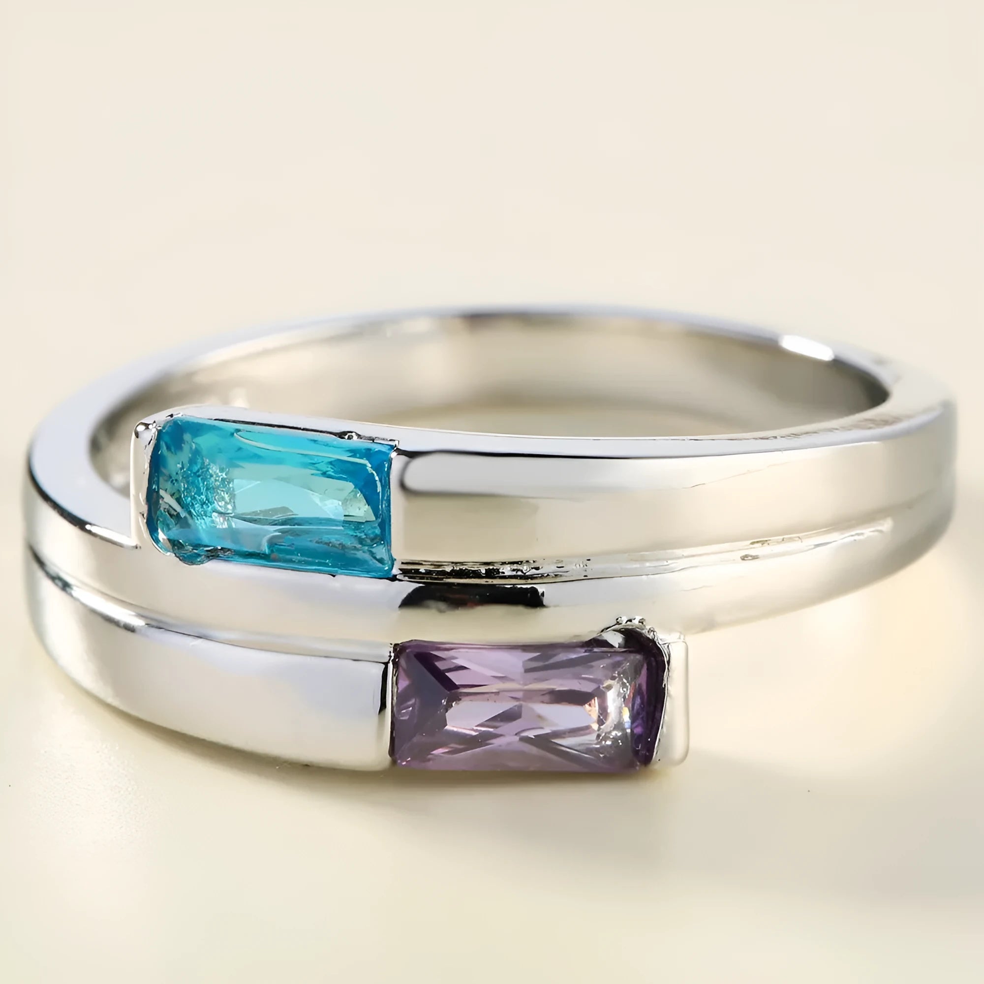 Copper ring with silver electroplated finish and inset zircon detail on a finger.