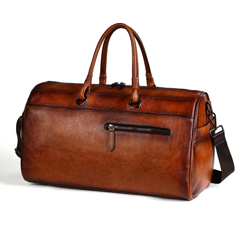 Handmade retro style leather travel bag in vintage brown colour showing expansion functionality